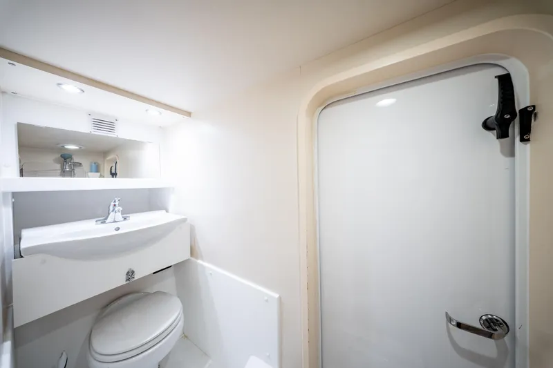  Yacht Photos Pics Bathroom interior of 1998 Donzi R73 yacht with sink, toilet, and shower door.