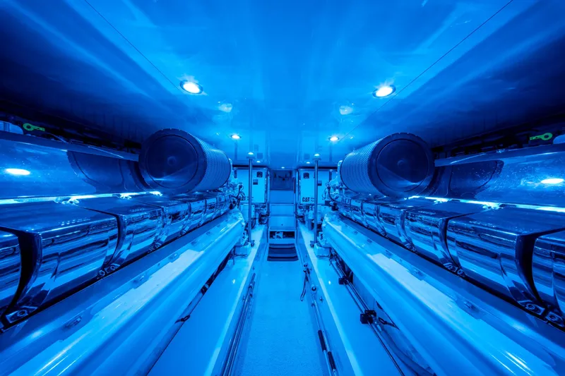  Yacht Photos Pics Engine room of 1998 Donzi R73 yacht with blue lighting and polished machinery.