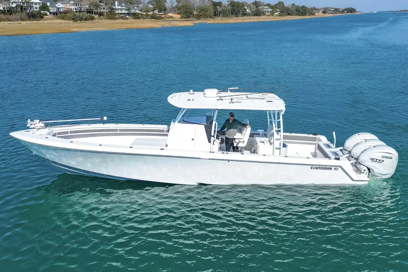  Yacht Photos Pics 2024 Contender 39 ST boat on clear blue water with triple Yamaha engines.