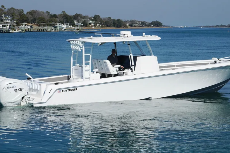  Yacht Photos Pics 2024 Contender 39 ST boat on calm water, featuring Yamaha XTO engines.