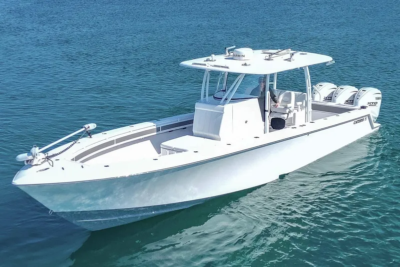  Yacht Photos Pics 2024 Contender 39 ST boat on clear blue water, featuring triple outboard engines.