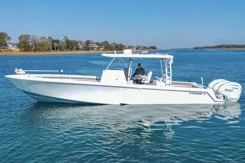  Yacht Photos Pics 2024 Contender 39 ST boat on calm water, featuring sleek design and powerful engines.