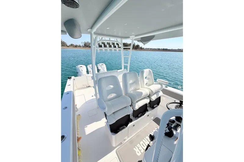  Yacht Photos Pics 2024 Contender 39 ST boat interior with white seating, ocean view in background.