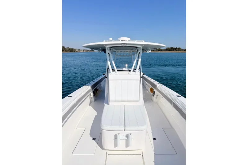  Yacht Photos Pics 2024 Contender 39 ST boat on calm water, showcasing sleek design and spacious deck.