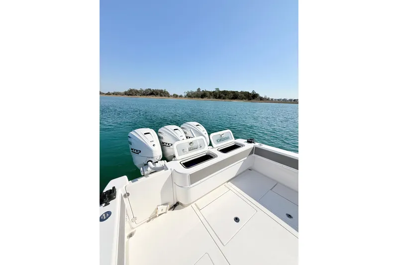  Yacht Photos Pics 2024 Contender 39 ST boat with triple outboard engines on calm water.