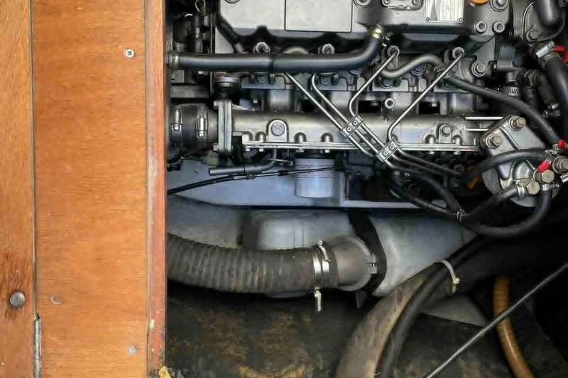  Yacht Photos Pics Engine compartment of a 2007 Lagoon 440 catamaran, showcasing mechanical components and hoses.