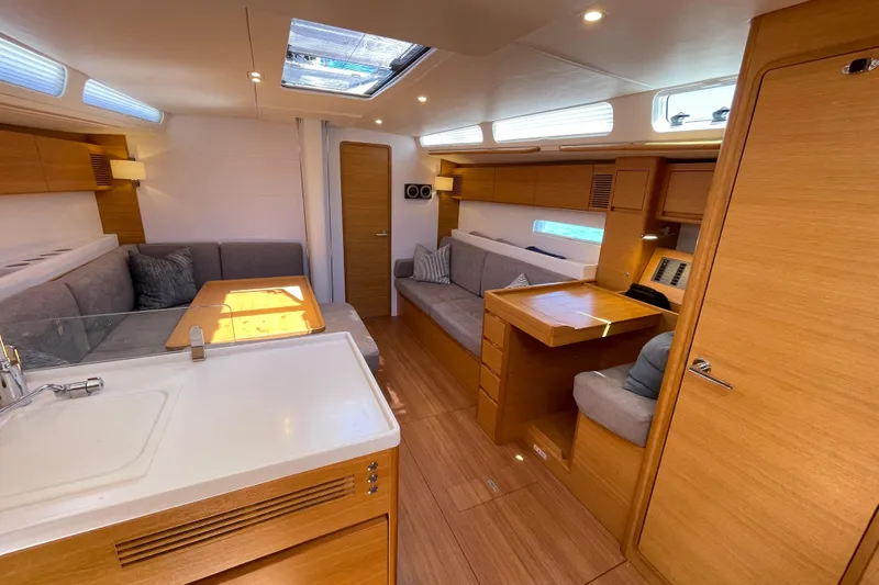  Yacht Photos Pics Luxurious interior of 2018 X-Yachts X4.9 sailboat with modern wood finish and seating area.