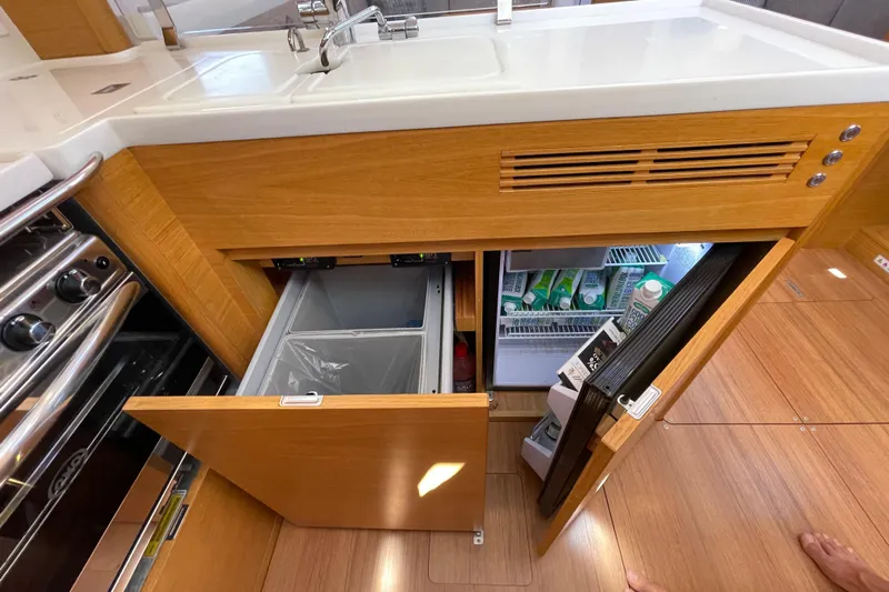  Yacht Photos Pics Modern kitchen area in 2018 X-Yachts X4.9, featuring a sink, stove, and refrigerator.