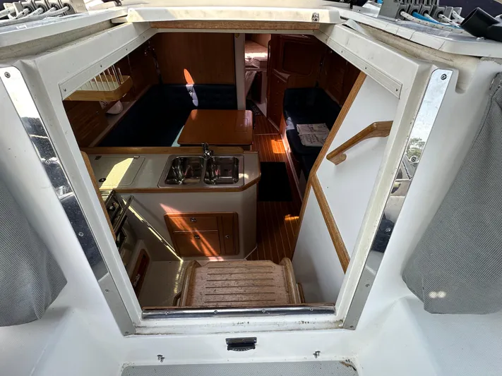 Wakes Yacht Photos Pics Interior view of 2005 Catalina 36 MkII sailboat, featuring kitchen and seating area.