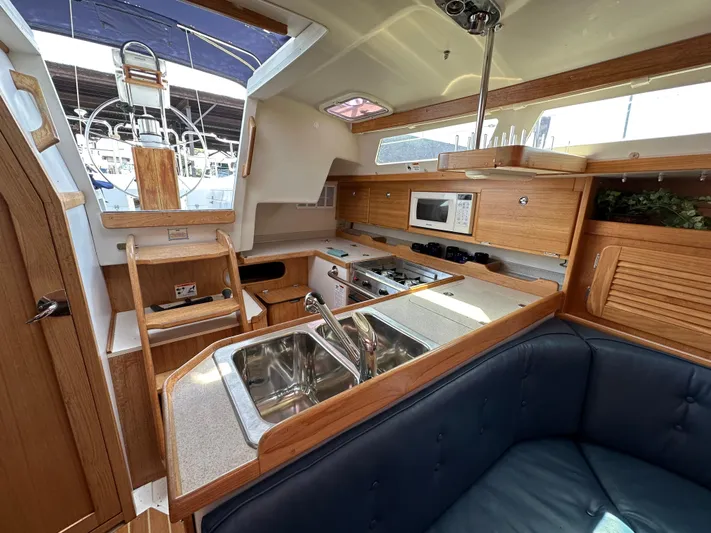 Wakes Yacht Photos Pics Interior of 2005 Catalina 36 MkII sailboat with kitchen, sink, and seating area.