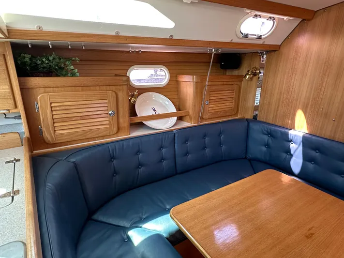 Wakes Yacht Photos Pics Interior of 2005 Catalina 36 MkII sailboat with blue seating and wooden cabinetry.