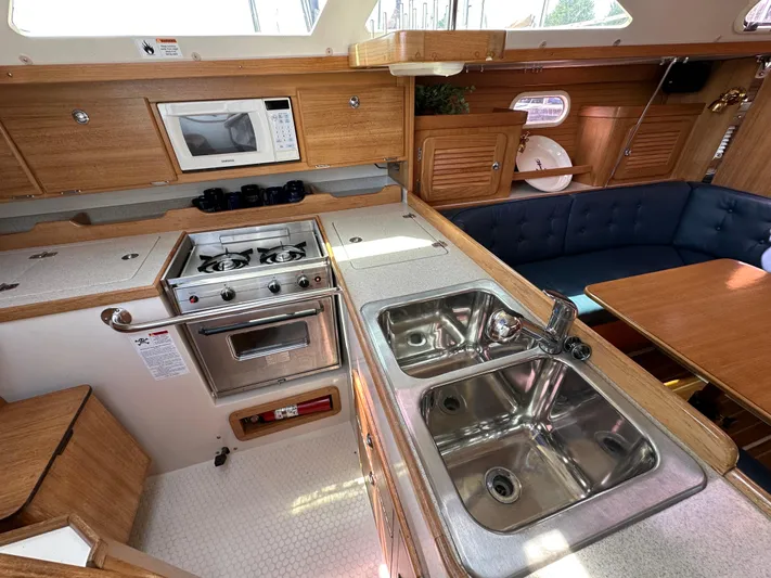 Wakes Yacht Photos Pics Catalina 36 MkII 2005 yacht interior with kitchen, stove, sink, and seating area.