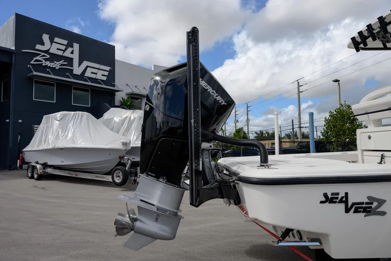  Yacht Photos Pics 2024 SeaVee 270Z boat with Mercury engine at SeaVee dealership under cloudy sky.