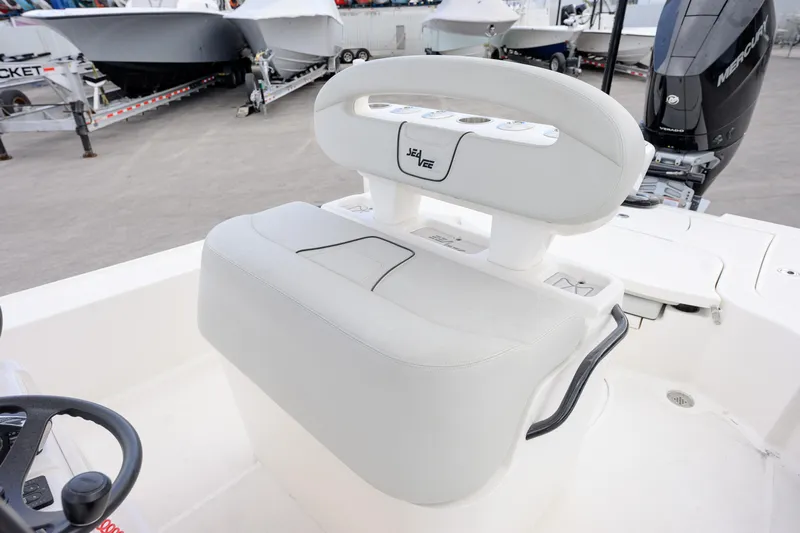  Yacht Photos Pics 2024 SeaVee 270Z boat with white seating and Mercury engine in a marina.