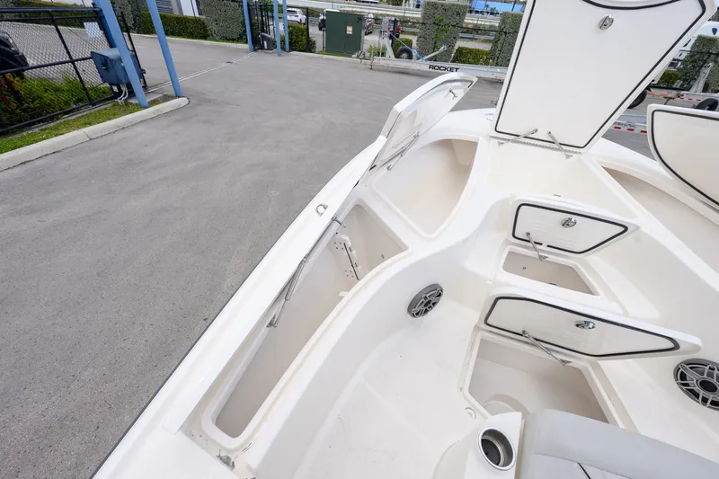  Yacht Photos Pics 2024 SeaVee 270Z boat deck with open storage compartments and seating area.