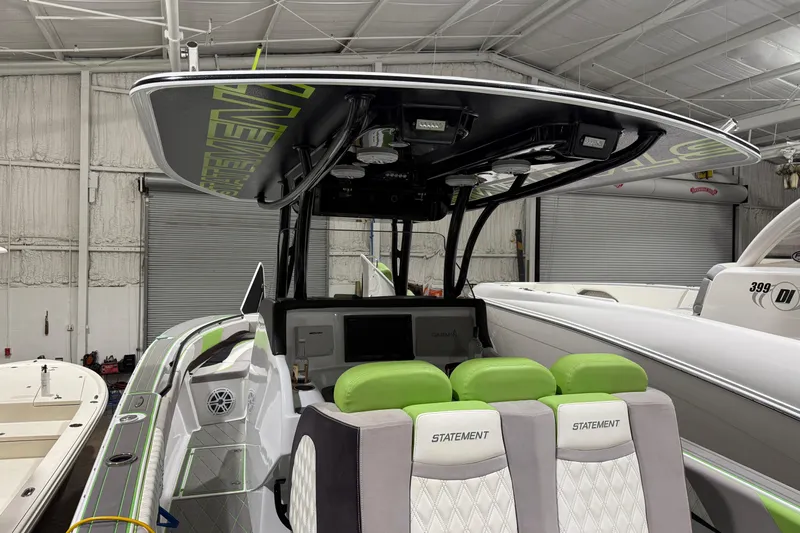  Yacht Photos Pics 2017 Statement 350 Open boat with green accents in a warehouse setting.