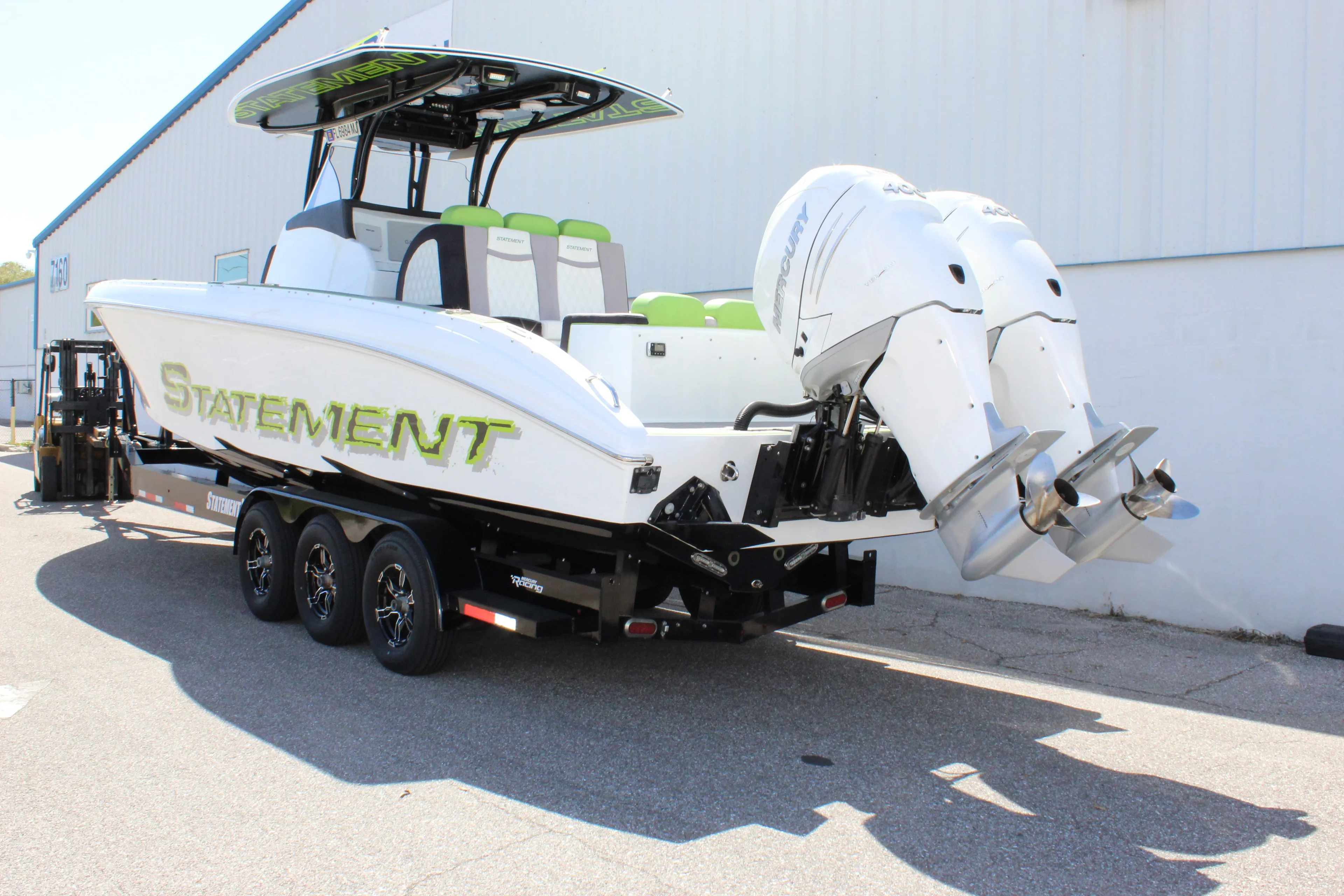 2017 Statement 350 Open boat on trailer with dual outboard engines.