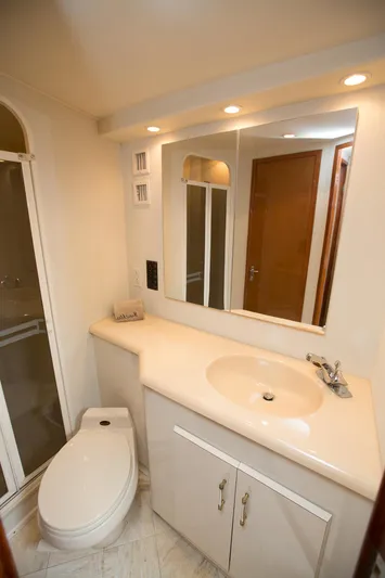  Yacht Photos Pics Bathroom interior of 2000 Viking 50 Convertible Sport Fisher yacht, featuring sink and toilet.