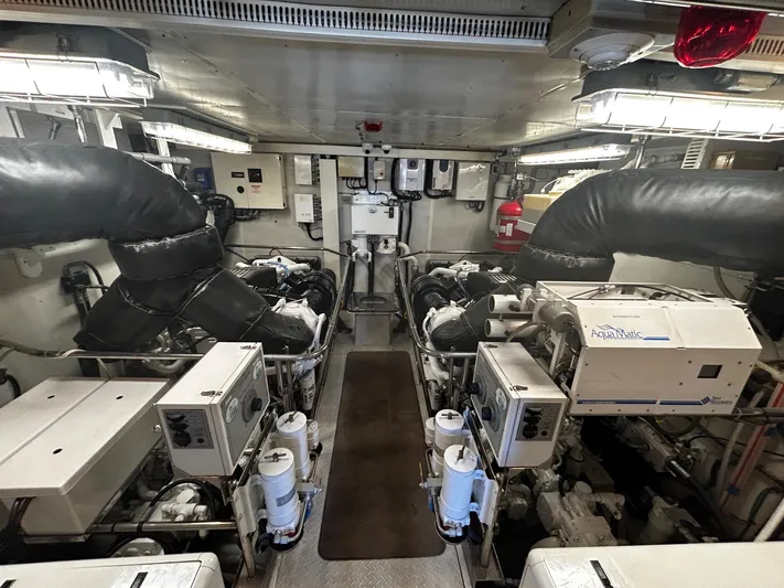 Sue Carolyn Yacht Photos Pics Engine room of a 2003 Hargrave Sky Lounge yacht, featuring dual engines and control systems.