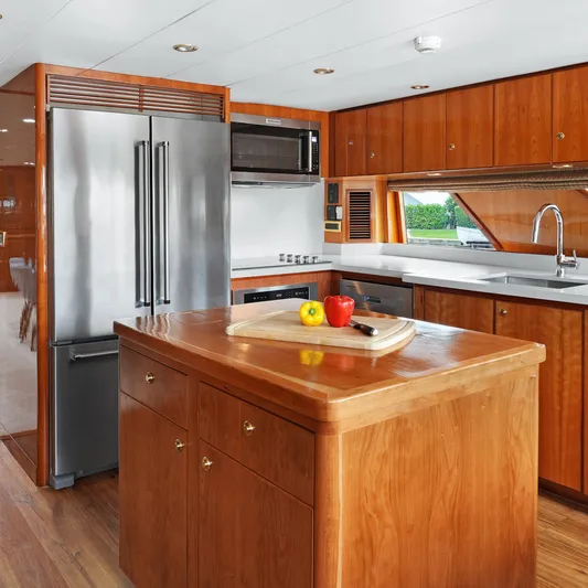 Sue Carolyn Yacht Photos Pics Luxurious kitchen in 2003 Hargrave Sky Lounge yacht with wooden cabinetry and modern appliances.