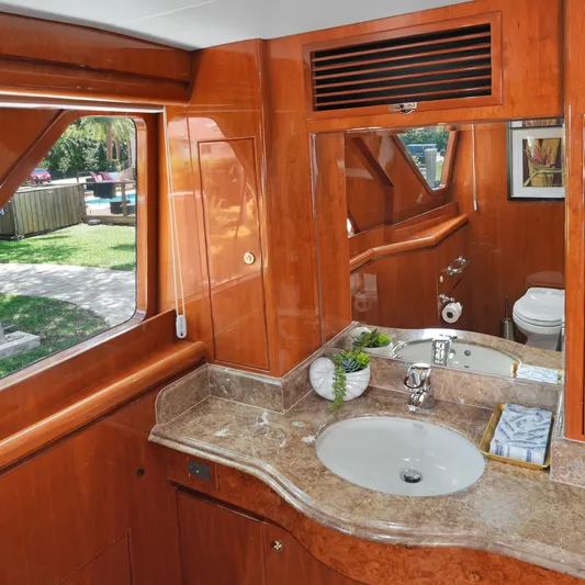 Sue Carolyn Yacht Photos Pics Luxurious bathroom interior on 2003 Hargrave Sky Lounge yacht with wood finish and marble countertop.