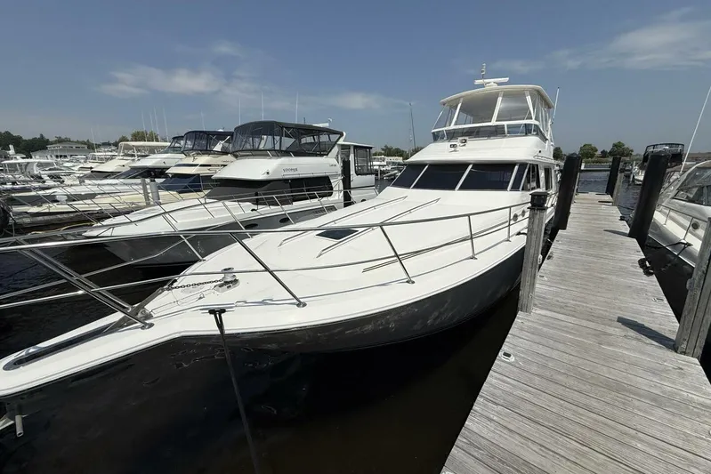  Yacht Photos Pics 1995 Sea Ray 550 Sedan Bridge yacht docked at marina under clear sky.