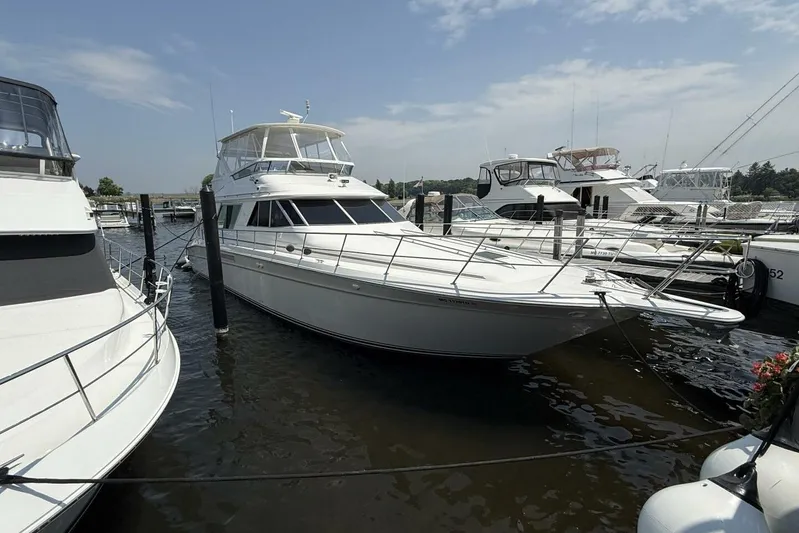  Yacht Photos Pics 1995 Sea Ray 550 Sedan Bridge yacht docked at marina under clear sky.