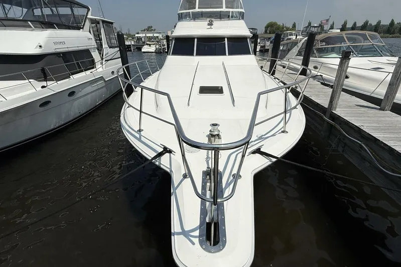  Yacht Photos Pics 1995 Sea Ray 550 Sedan Bridge yacht docked at marina, front view.