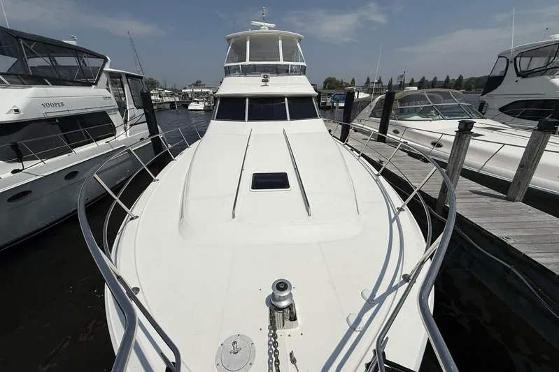  Yacht Photos Pics 1995 Sea Ray 550 Sedan Bridge yacht docked at marina, surrounded by other boats.