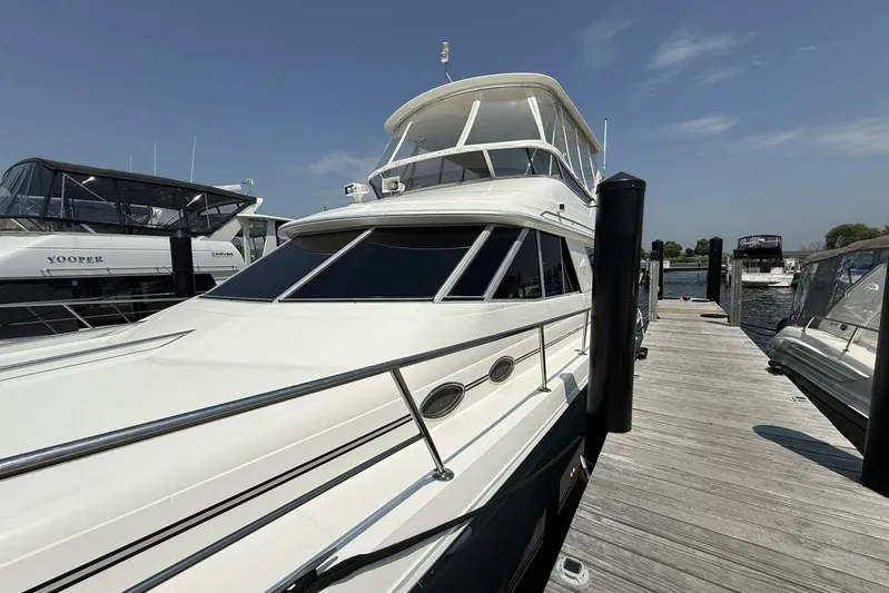  Yacht Photos Pics 1995 Sea Ray 550 Sedan Bridge yacht docked at marina under clear sky.