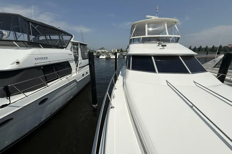  Yacht Photos Pics 1995 Sea Ray 550 Sedan Bridge yacht docked beside another boat.