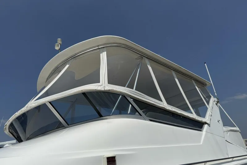  Yacht Photos Pics 1995 Sea Ray 550 Sedan Bridge yacht with enclosed flybridge under clear blue sky.