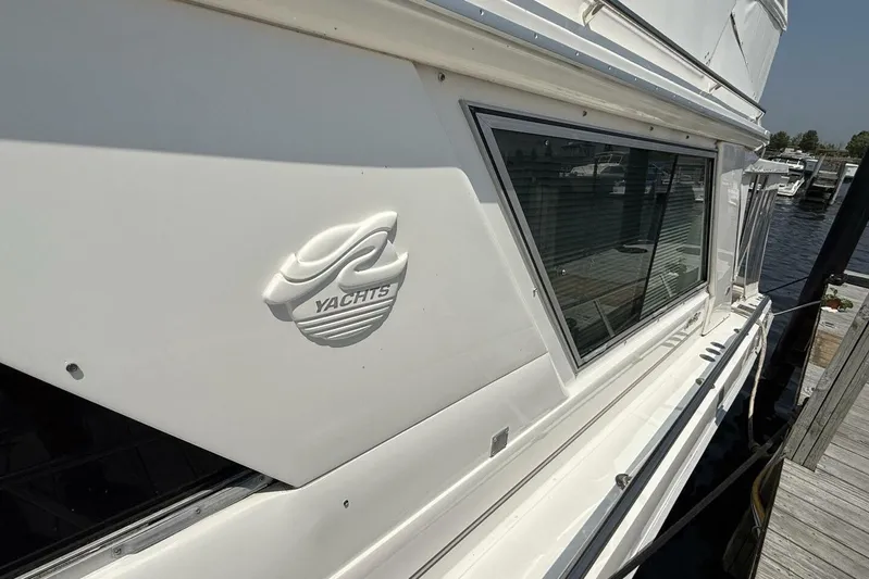  Yacht Photos Pics 1995 Sea Ray 550 Sedan Bridge yacht docked, showcasing sleek design and window detail.