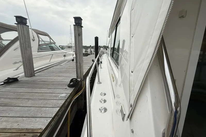  Yacht Photos Pics 1995 Sea Ray 550 Sedan Bridge yacht docked at marina, side view.