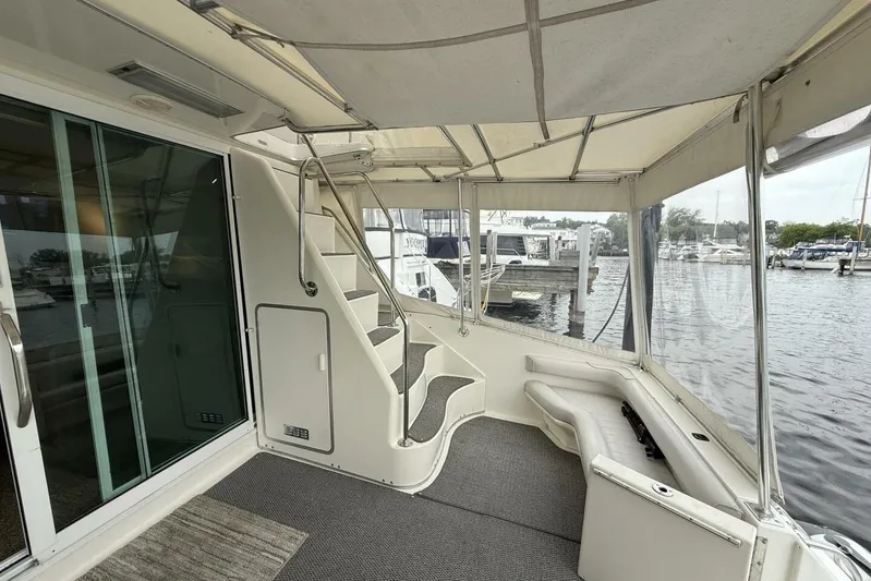  Yacht Photos Pics 1995 Sea Ray 550 Sedan Bridge yacht interior with stairs and marina view.