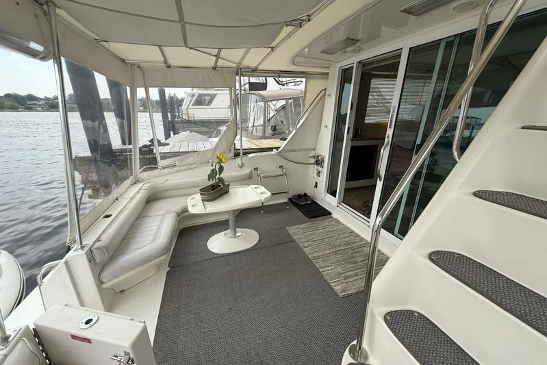  Yacht Photos Pics 1995 Sea Ray 550 Sedan Bridge yacht interior with seating, table, and water view.