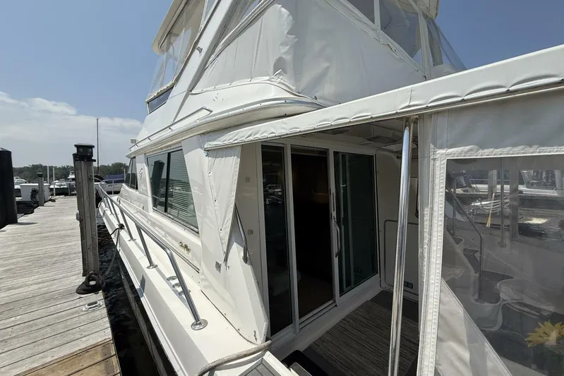  Yacht Photos Pics 1995 Sea Ray 550 Sedan Bridge yacht docked, featuring sleek white exterior and spacious deck.