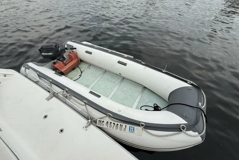  Yacht Photos Pics Inflatable boat with Mercury motor docked beside Sea Ray 550 Sedan Bridge, 1995 model.