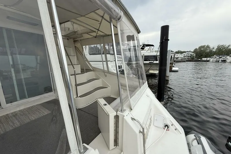  Yacht Photos Pics 1995 Sea Ray 550 Sedan Bridge yacht docked at marina, featuring stairs and enclosed deck.