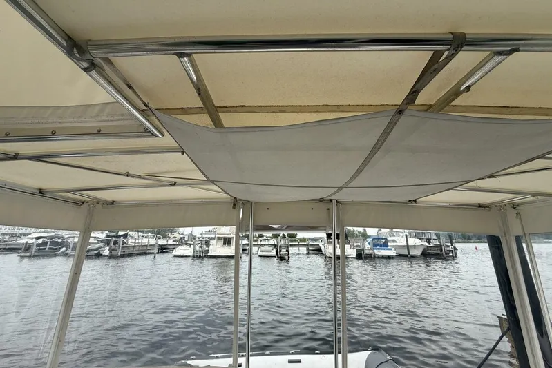  Yacht Photos Pics 1995 Sea Ray 550 Sedan Bridge interior view with marina backdrop.