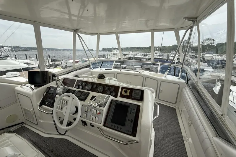  Yacht Photos Pics 1995 Sea Ray 550 Sedan Bridge helm with panoramic marina view.