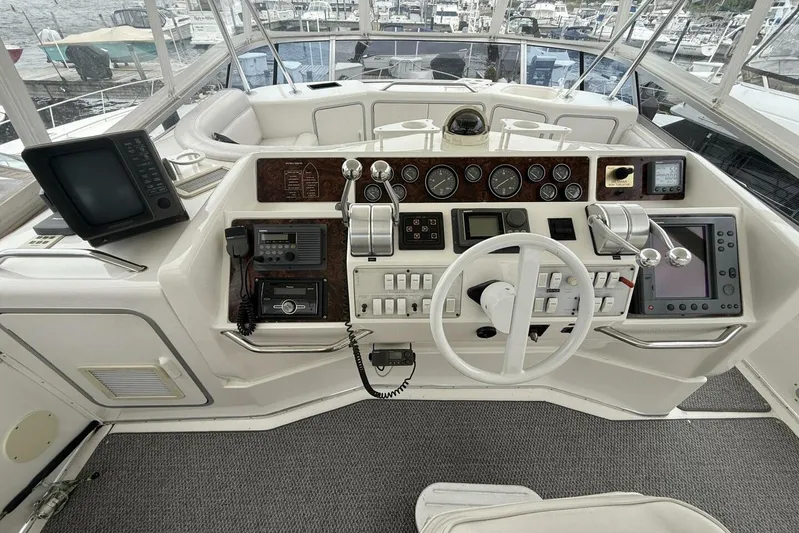  Yacht Photos Pics Cockpit of 1995 Sea Ray 550 Sedan Bridge with navigation instruments and steering wheel.