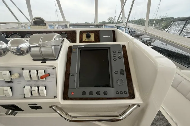  Yacht Photos Pics 1995 Sea Ray 550 Sedan Bridge helm with navigation controls and Raymarine display.