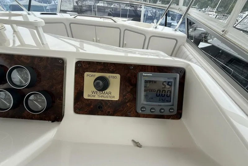  Yacht Photos Pics 1995 Sea Ray 550 Sedan Bridge dashboard with gauges and bow thruster controls.