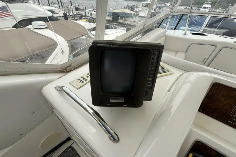  Yacht Photos Pics 1995 Sea Ray 550 Sedan Bridge helm with Furuno navigation display and marina view.
