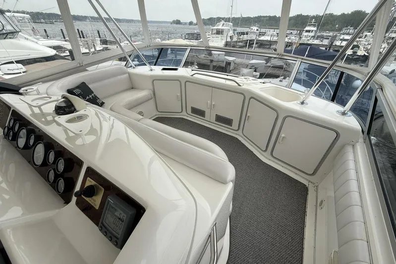  Yacht Photos Pics 1995 Sea Ray 550 Sedan Bridge interior with helm, seating, and marina view.