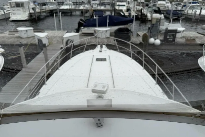  Yacht Photos Pics 1995 Sea Ray 550 Sedan Bridge yacht docked at marina, view from bow.