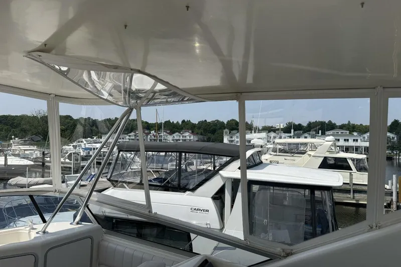  Yacht Photos Pics 1995 Sea Ray 550 Sedan Bridge yacht docked at marina with other boats.