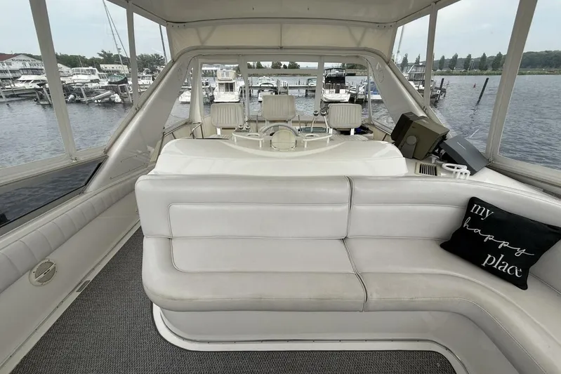  Yacht Photos Pics 1995 Sea Ray 550 Sedan Bridge interior with white seating and "my happy place" pillow.