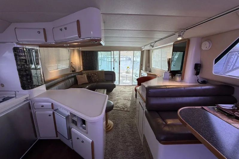  Yacht Photos Pics Luxurious interior of a 1995 Sea Ray 550 Sedan Bridge yacht with elegant seating and decor.